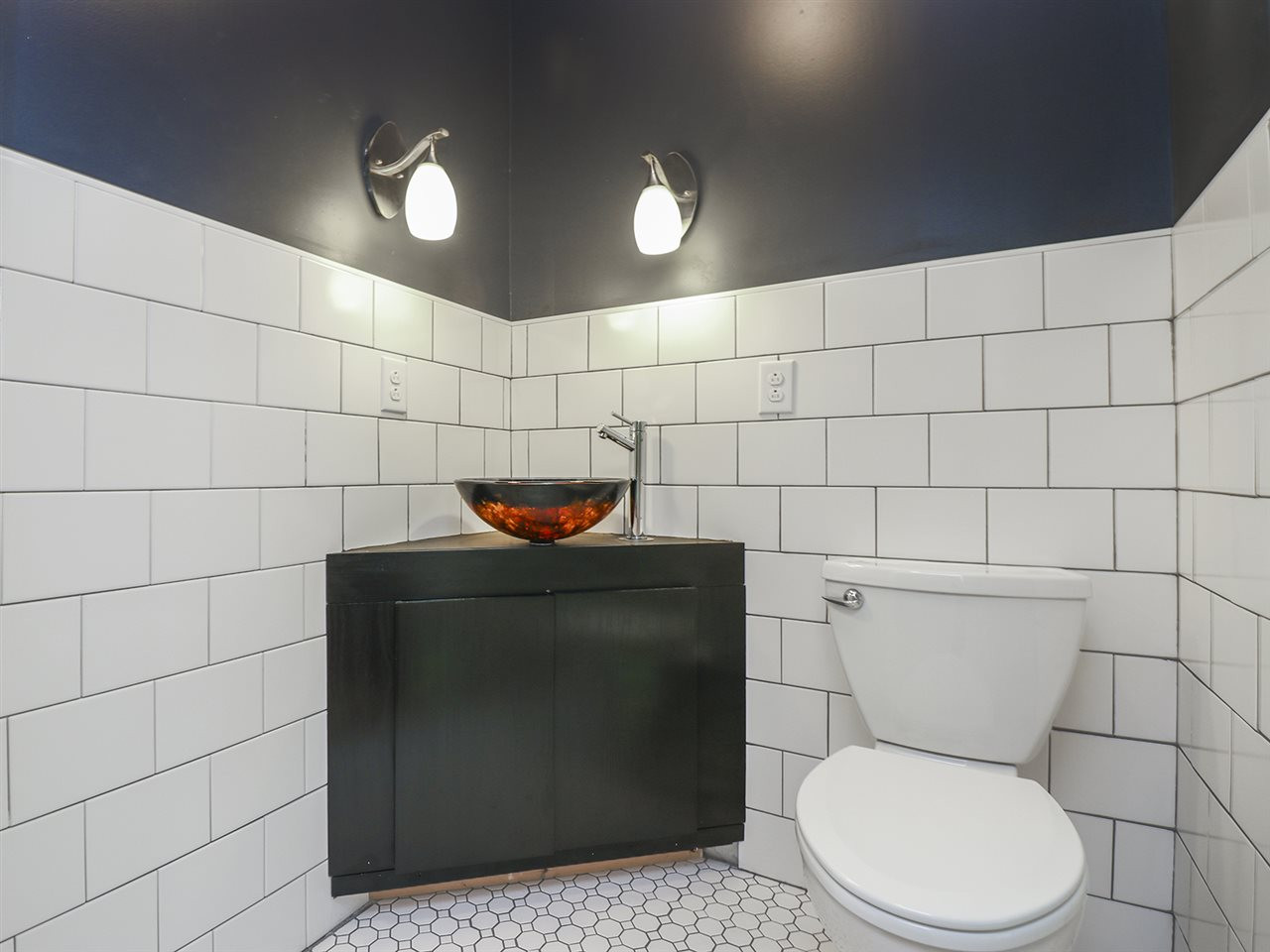 204 Proctor Street Zebulon, NC 27597 - Photo 28 of 30 a bathroom with a toilet and a sink