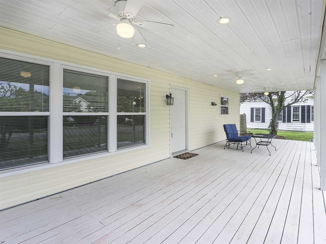 204 Proctor Street Zebulon, NC 27597 - Photo 4 of 30 a view of a hall with wooden floor and fence