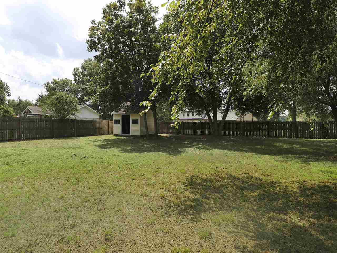 204 Proctor Street Zebulon, NC 27597 - Photo 6 of 30 a view of a yard with a trees