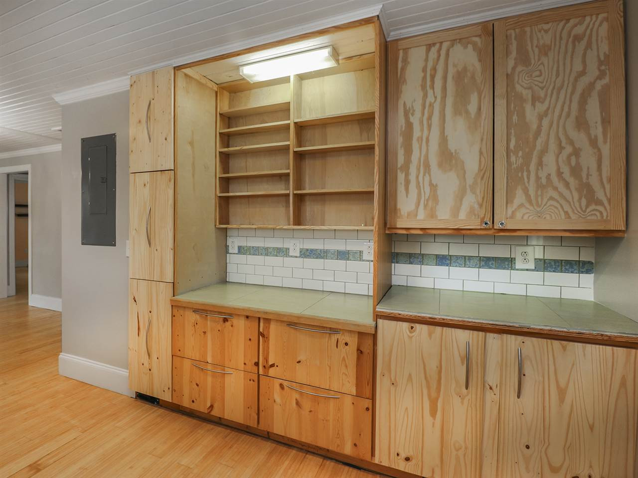 204 Proctor Street Zebulon, NC 27597 - Photo 9 of 30 a kitchen with cabinets and a wooden floor