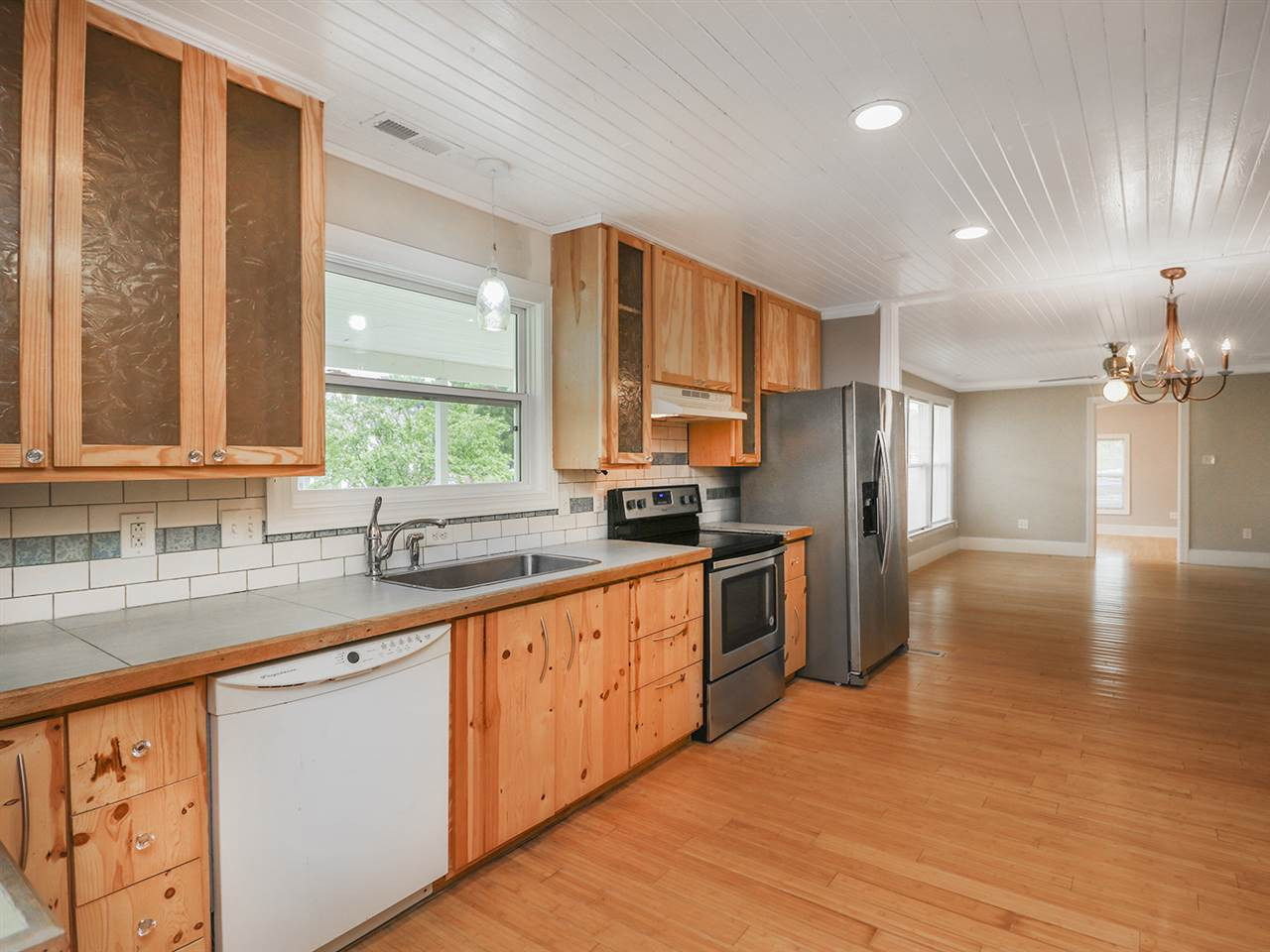 204 Proctor Street Zebulon, NC 27597 - Photo 10 of 30 a kitchen with stainless steel appliances granite countertop a sink a stove and refrigerator