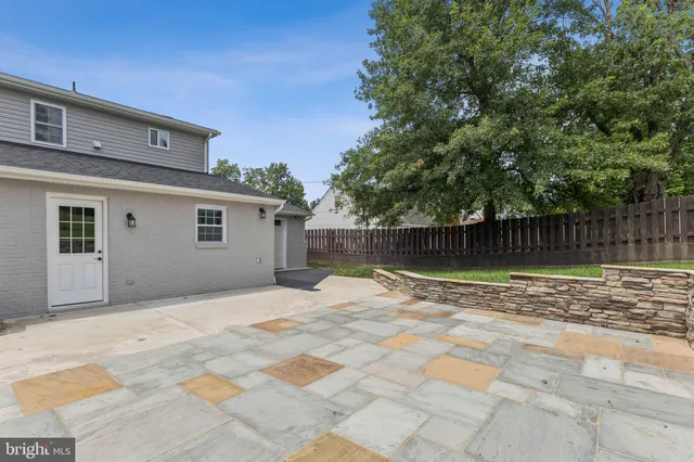 a view of a yard with wooden fence