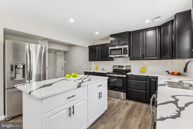 a kitchen with a sink stainless steel appliances and cabinets