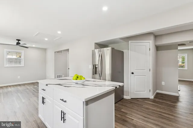a kitchen with a sink cabinets and wooden floor
