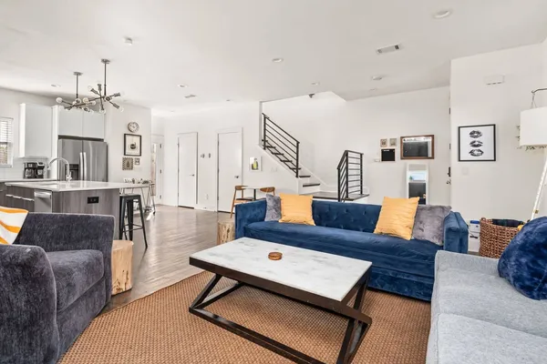 a living room with furniture and a chandelier