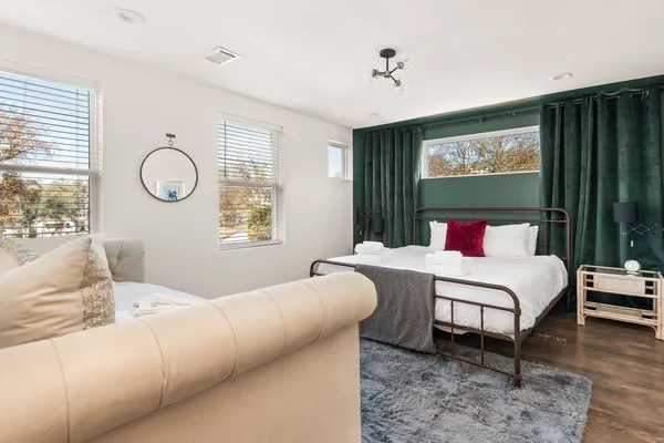 a bedroom with a bed and a large window