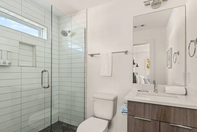 a bathroom with a sink toilet and shower
