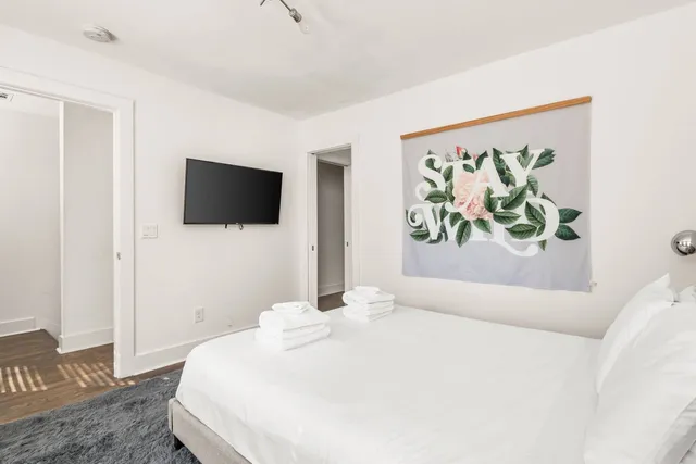 a bedroom with a bed and a flat screen tv