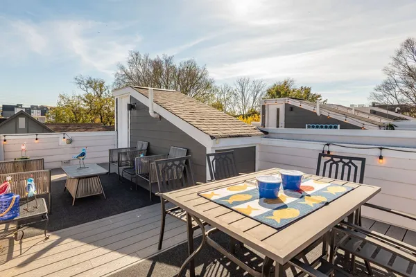 a terrace with outdoor seating and wooden floor