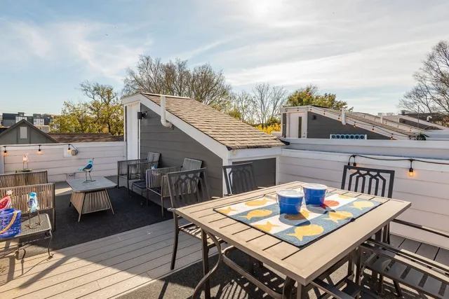 a terrace with outdoor seating and wooden floor