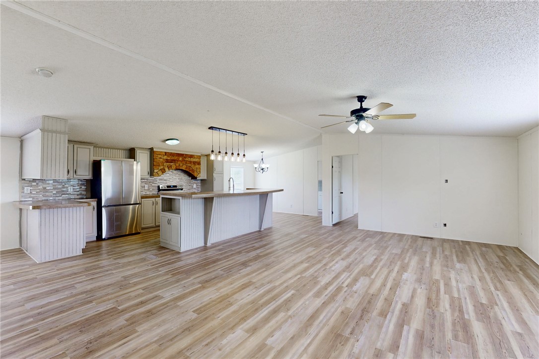 11459 Winstead Lane Calvert, TX 77837 - Photo 36 of 37 a view of a kitchen with wooden floor and electronic appliances
