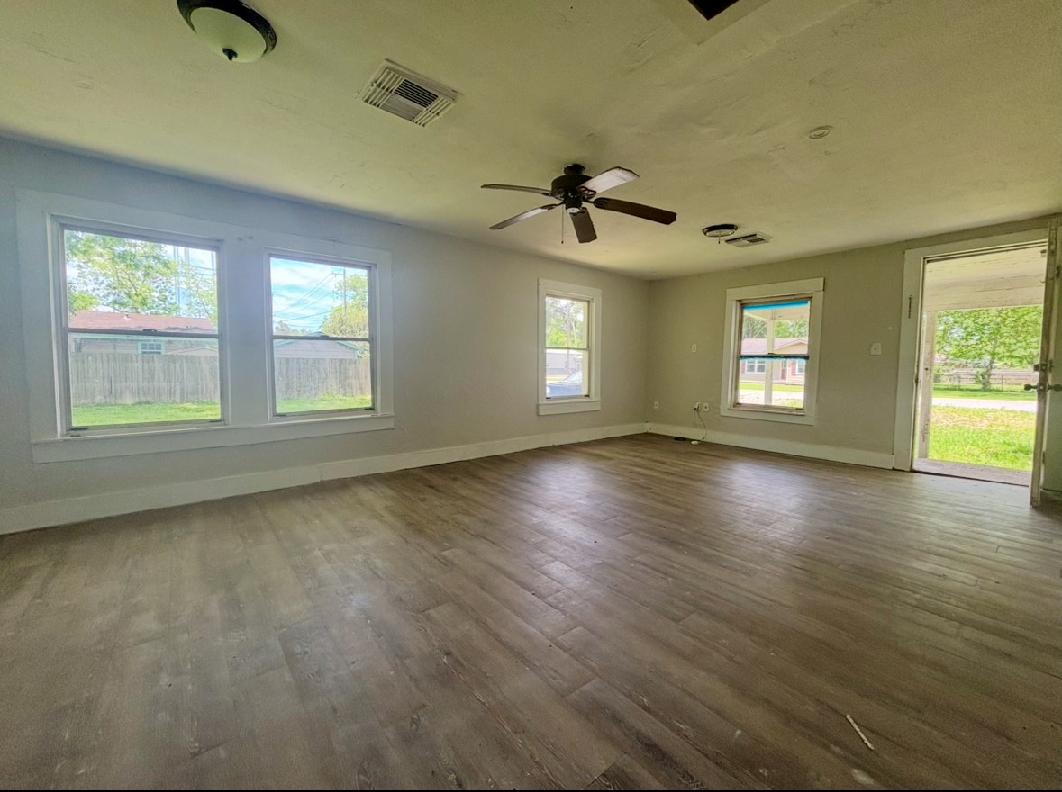 701 North Hackberry Street Sweeny, TX 77480 - Photo 7 of 12 a view of an empty room with wooden floor and a window