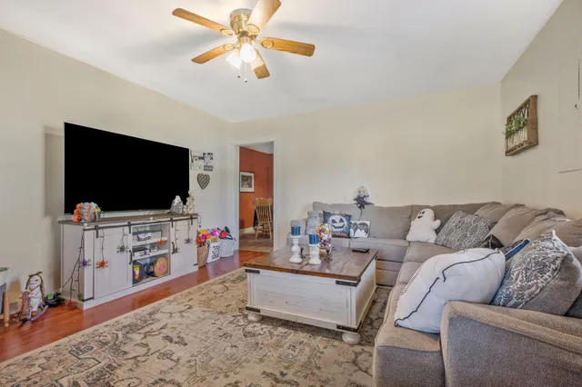 a living room with furniture and a flat screen tv