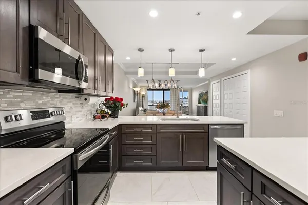 a kitchen with a sink and stove top oven