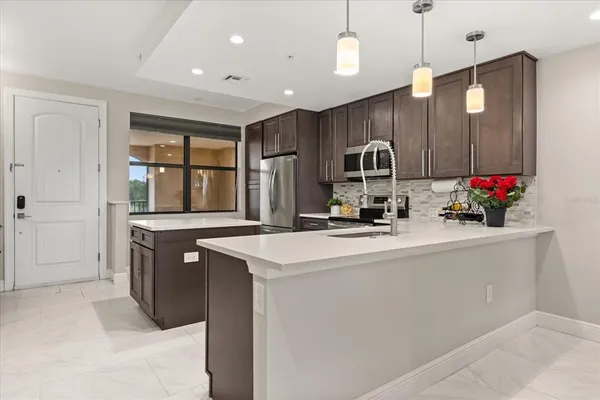a kitchen with stainless steel appliances a sink stove and a refrigerator