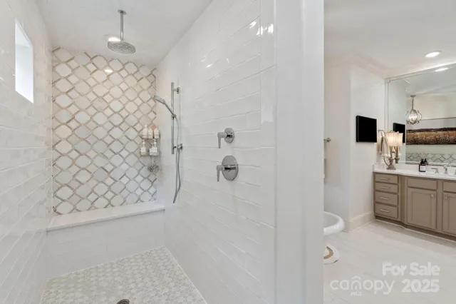 a bathroom with a shower sink and mirror