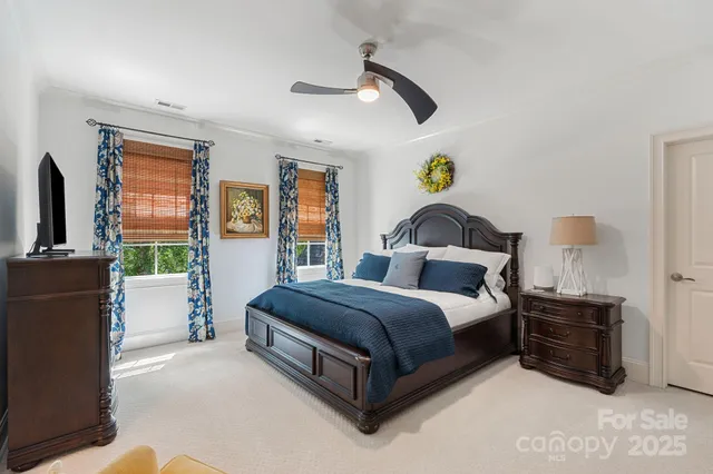 a spacious bedroom with a bed and a chandelier