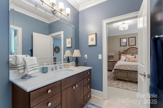 a en suite bathroom with a sink double vanity and mirror