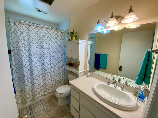 a kitchen with stainless steel appliances a table chairs in it and a window