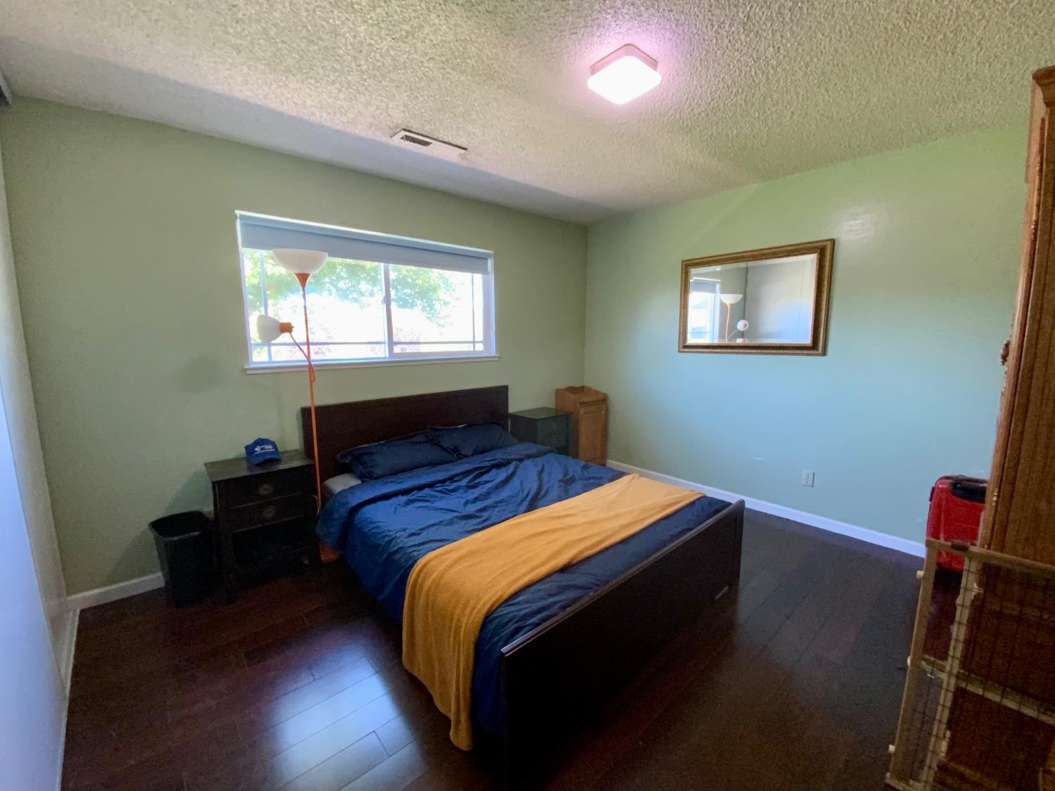 2367 Ponderosa Road Rescue, CA 95672 - Photo 17 of 76 a bedroom with a bed and wooden floor