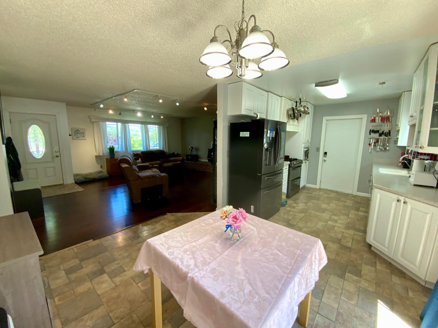 2367 Ponderosa Road Rescue, CA 95672 - Photo 26 of 76 a kitchen with stainless steel appliances kitchen island granite countertop a refrigerator a stove top oven and couches with wooden floor