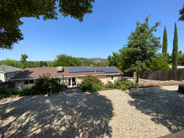 a view of a patio with chairs and potted plants
