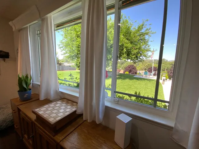 a bedroom with a bed and a window