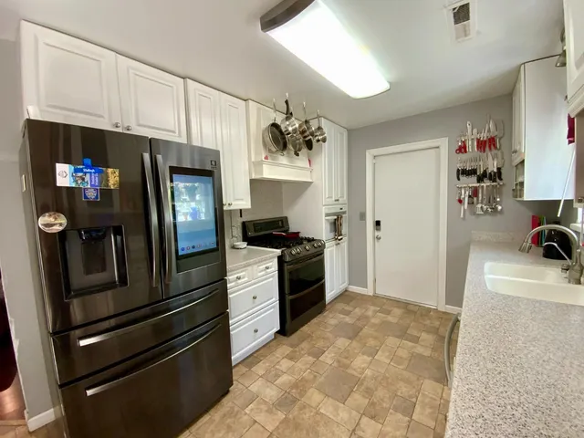 a living room with furniture a fireplace and a floor to ceiling window
