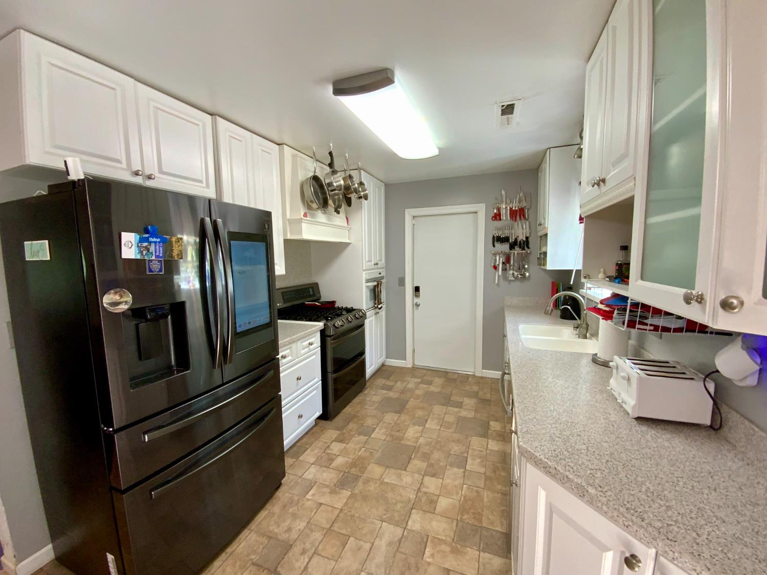 2367 Ponderosa Road Rescue, CA 95672 - Photo 10 of 76 a kitchen with granite countertop a refrigerator and a sink