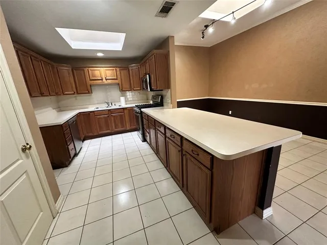 a view of room with wooden floor and a ceiling fan