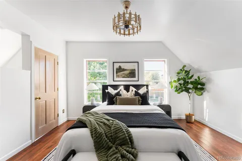 a bedroom with a bed and a painting on the wall