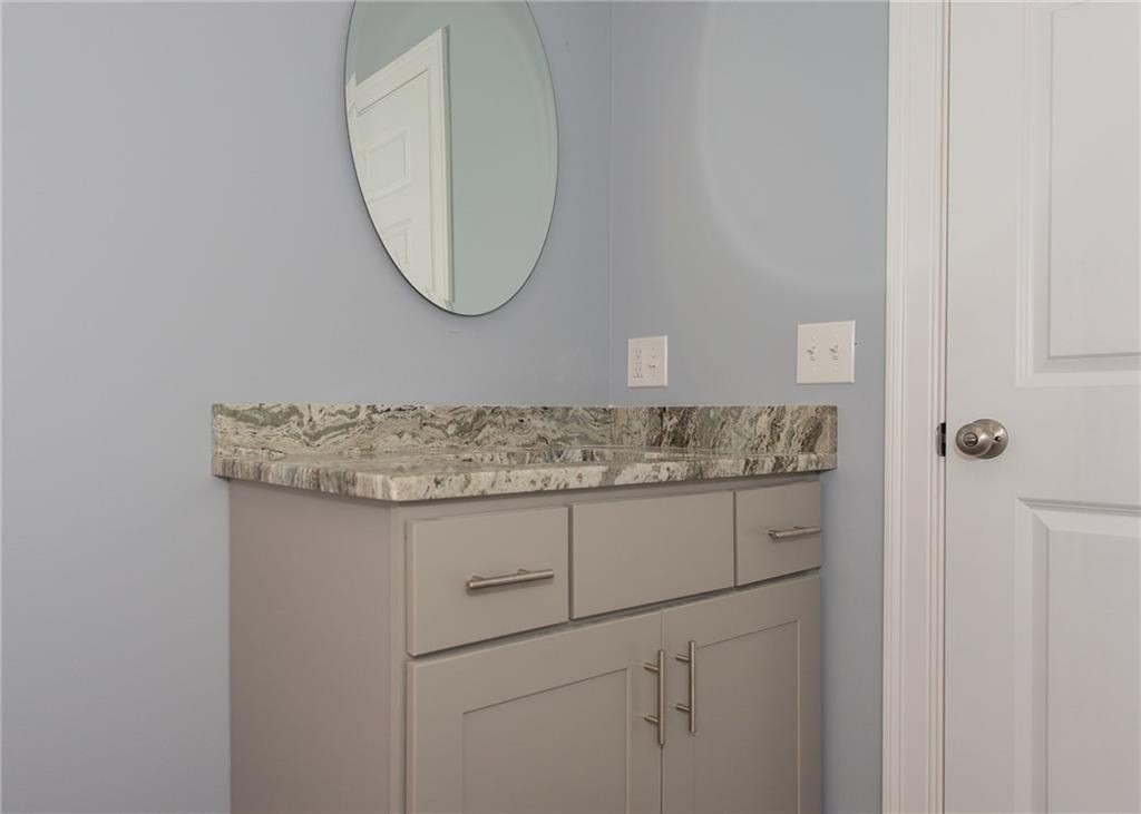 0 Bulgarmarsh Road, Unit 1 Tiverton, RI 02878 - Photo 13 of 19 a bathroom with a granite countertop sink and a mirror