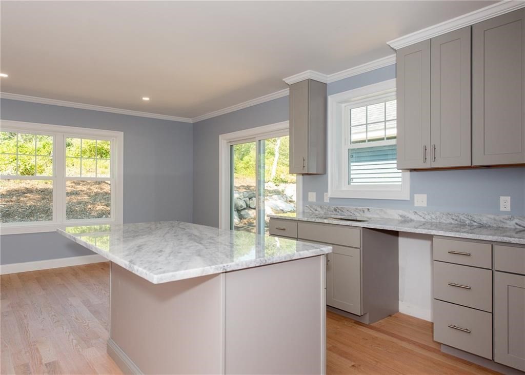 0 Bulgarmarsh Road, Unit 1 Tiverton, RI 02878 - Photo 8 of 19 a kitchen with granite countertop a sink and a window