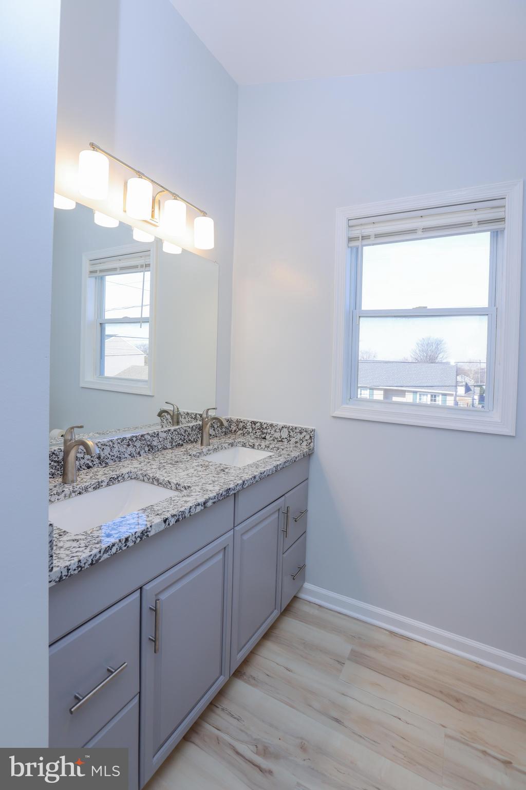 30 Queen Anne Road Glen Burnie, MD 21060 - Photo 19 of 47 a bathroom with a granite countertop sink and a mirror