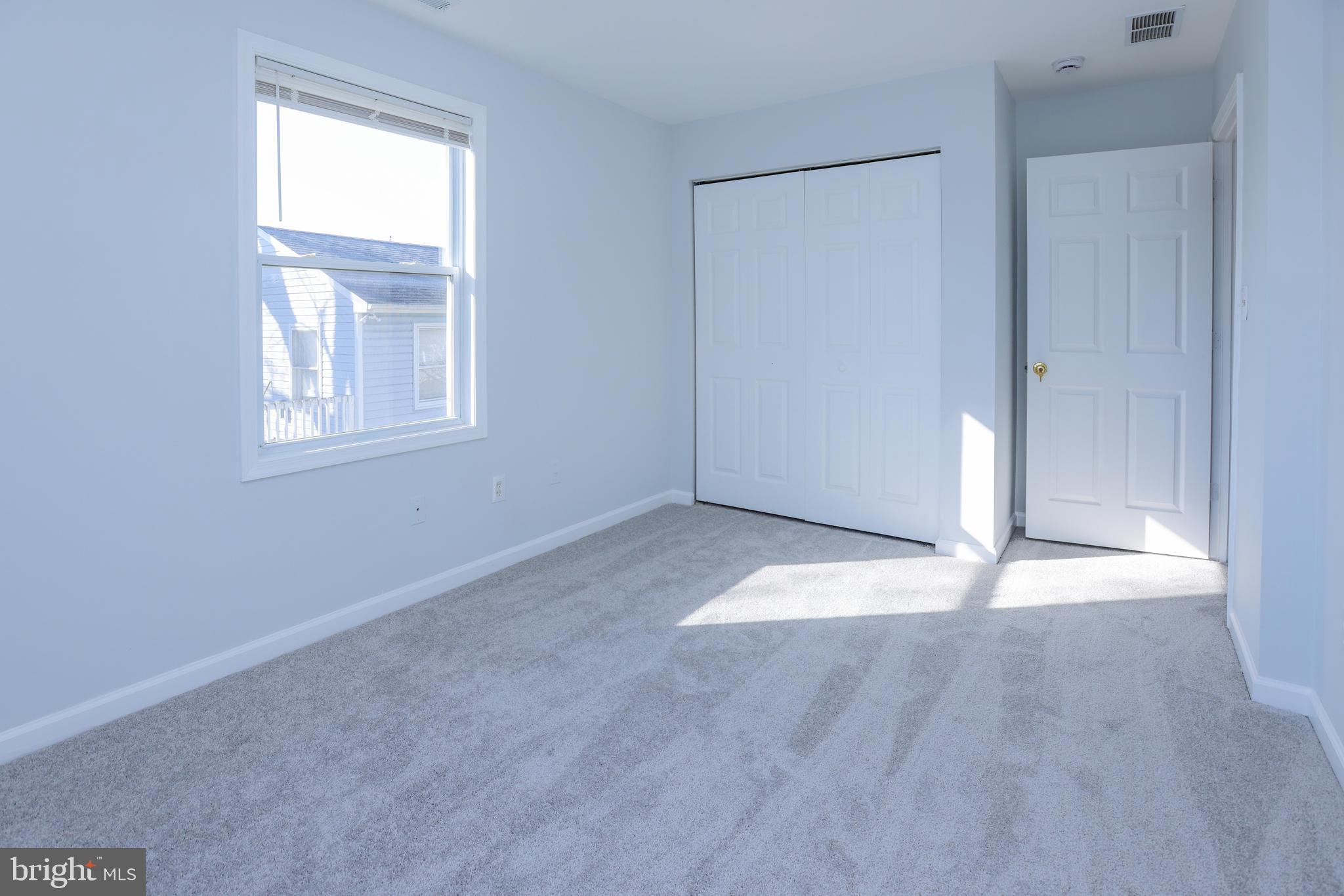 30 Queen Anne Road Glen Burnie, MD 21060 - Photo 28 of 47 an empty room with windows and closet