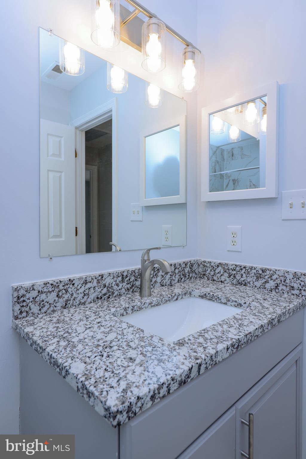 30 Queen Anne Road Glen Burnie, MD 21060 - Photo 30 of 47 a bathroom with a granite countertop sink and a mirror