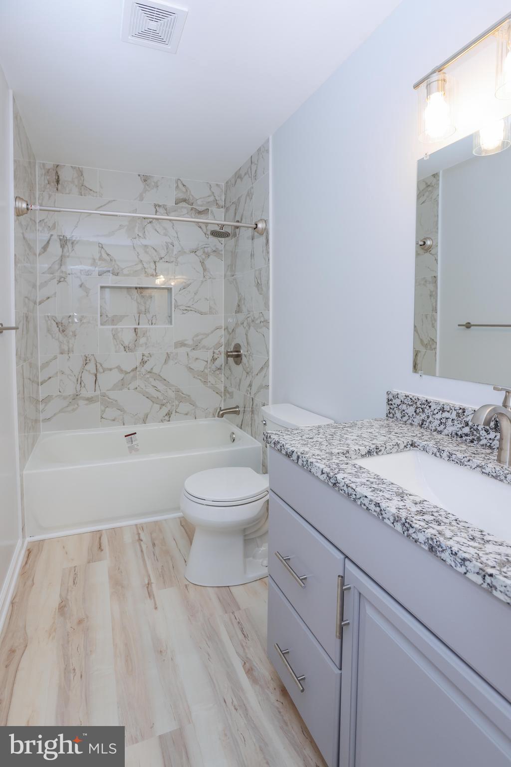 30 Queen Anne Road Glen Burnie, MD 21060 - Photo 33 of 47 a bathroom with a granite countertop sink a toilet and shower
