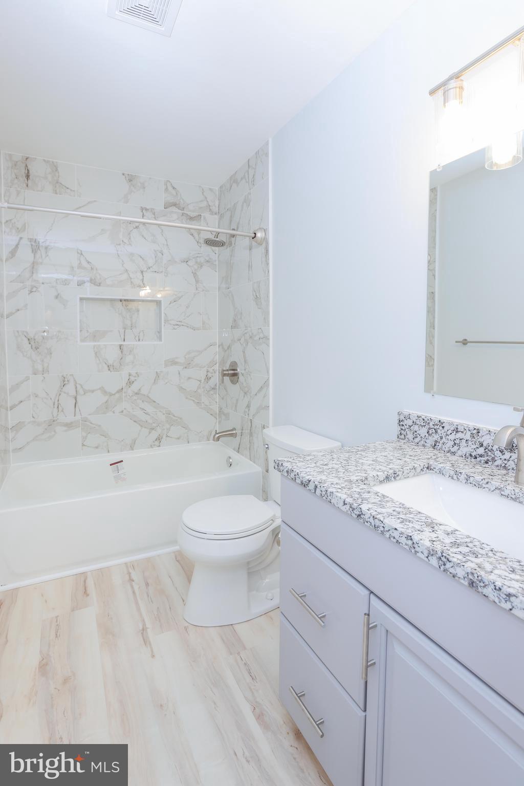 30 Queen Anne Road Glen Burnie, MD 21060 - Photo 34 of 47 a bathroom with a granite countertop toilet a sink and bathtub