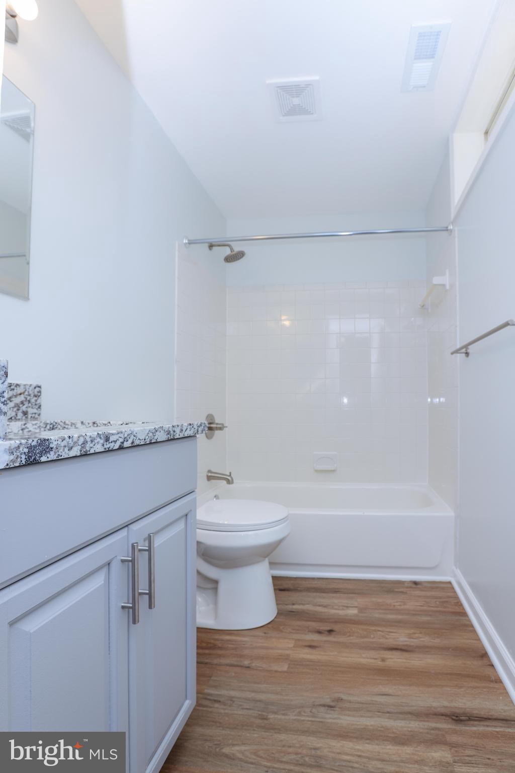 30 Queen Anne Road Glen Burnie, MD 21060 - Photo 40 of 47 a bathroom with a granite countertop sink a toilet and bathtub