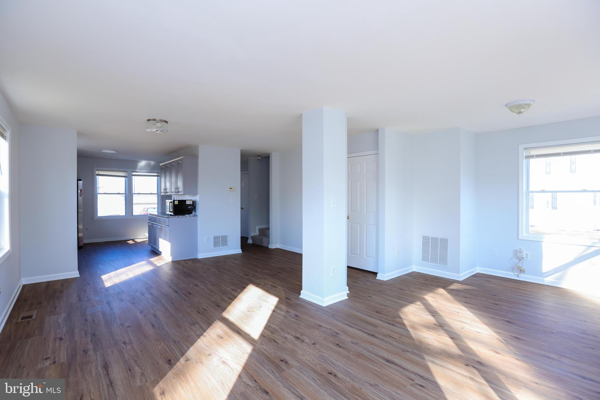30 Queen Anne Road Glen Burnie, MD 21060 - Photo 4 of 47 a view of empty room with wooden floor and windows