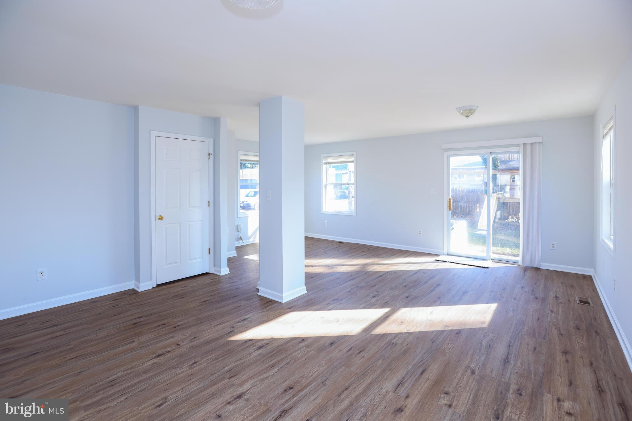 30 Queen Anne Road Glen Burnie, MD 21060 - Photo 5 of 47 a view of an empty room with wooden floor and a window