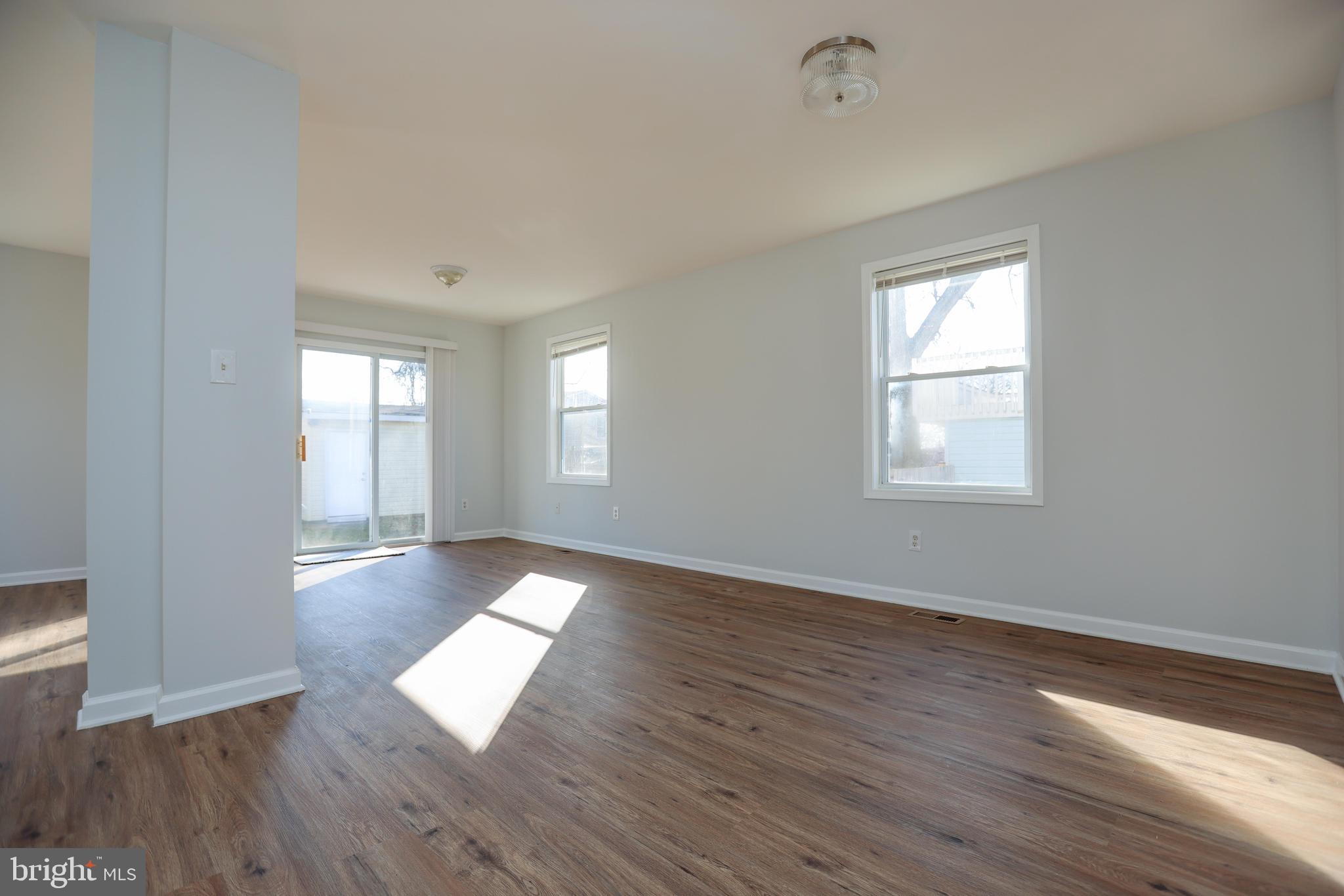 30 Queen Anne Road Glen Burnie, MD 21060 - Photo 7 of 47 an empty room with wooden floor and windows