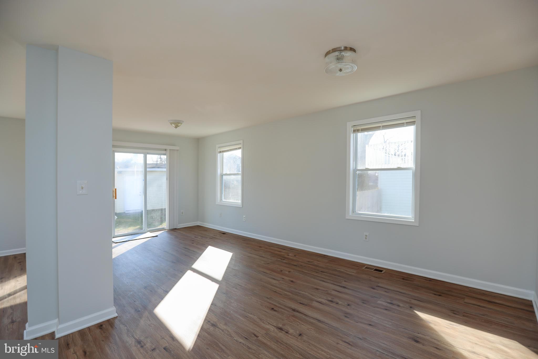 30 Queen Anne Road Glen Burnie, MD 21060 - Photo 8 of 47 an empty room with wooden floor and windows