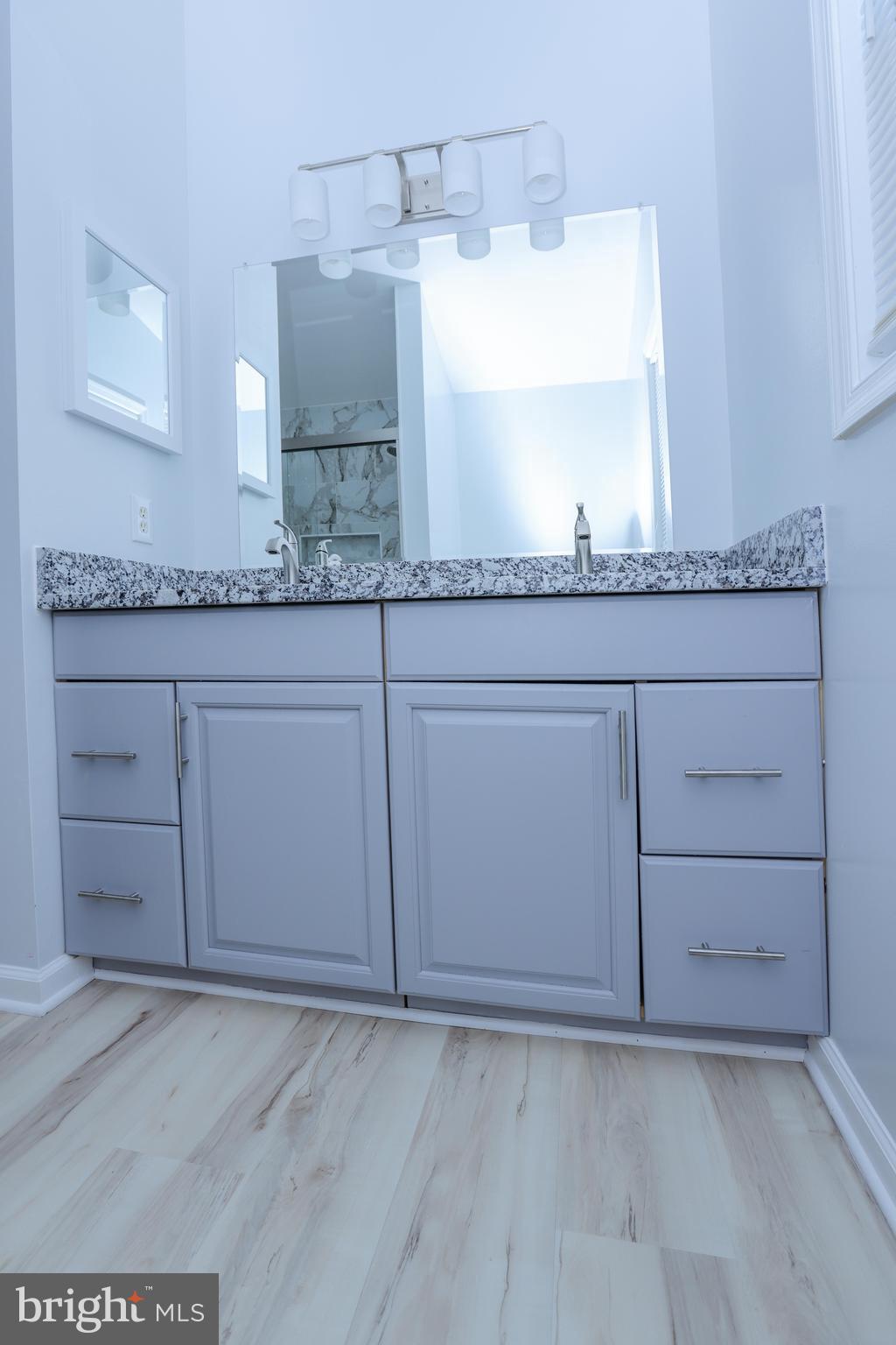 30 Queen Anne Road Glen Burnie, MD 21060 - Photo 9 of 47 a bathroom with a granite countertop sink and a mirror