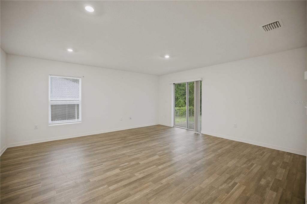 260 Emerald Road Ocala, FL 34472 - Photo 11 of 29 a view of an empty room with wooden floor and a window