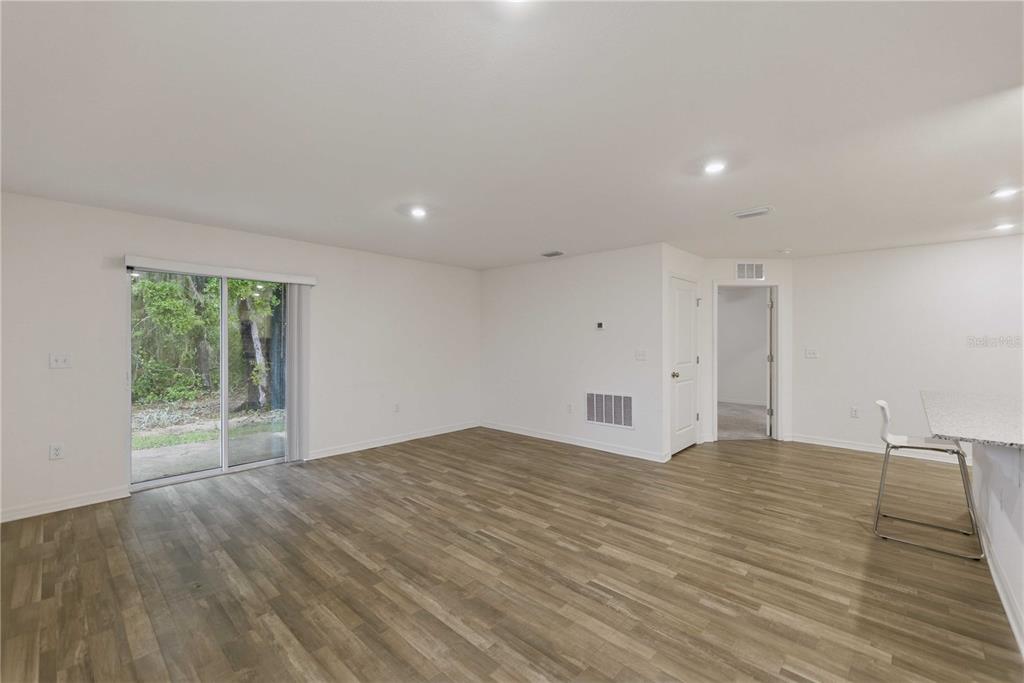 260 Emerald Road Ocala, FL 34472 - Photo 14 of 29 a view of an empty room with wooden floor and a window