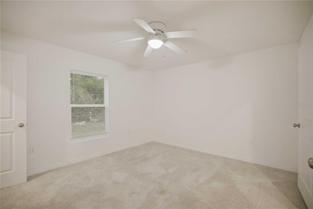 260 Emerald Road Ocala, FL 34472 - Photo 15 of 29 an empty room with a window and a fan