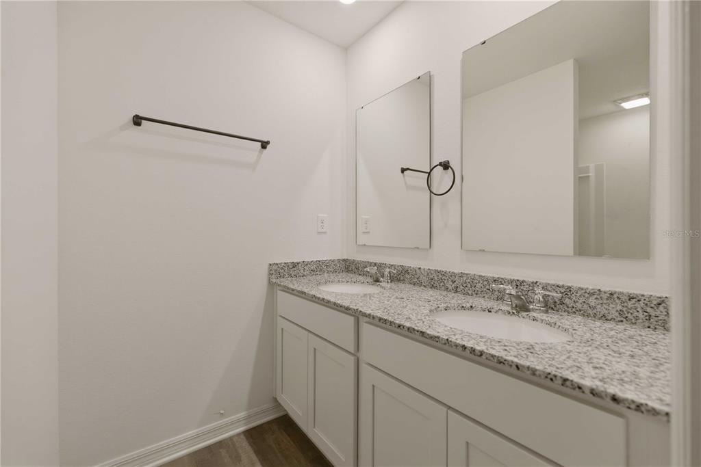 260 Emerald Road Ocala, FL 34472 - Photo 18 of 29 a bathroom with a granite countertop sink and a mirror