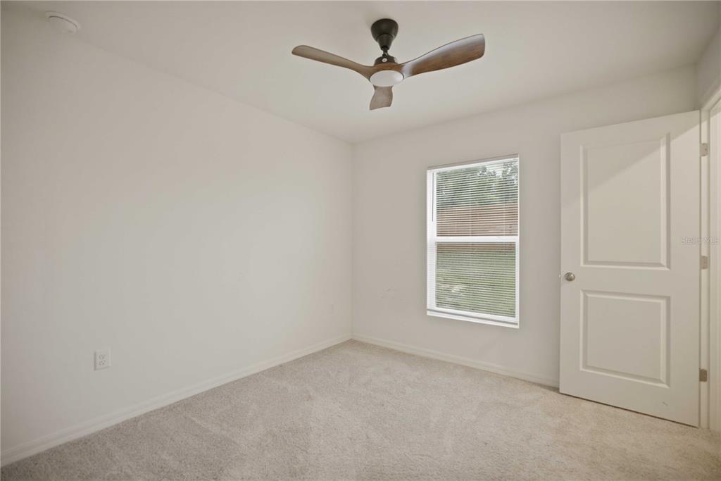 260 Emerald Road Ocala, FL 34472 - Photo 20 of 29 an empty room with a window and a fan