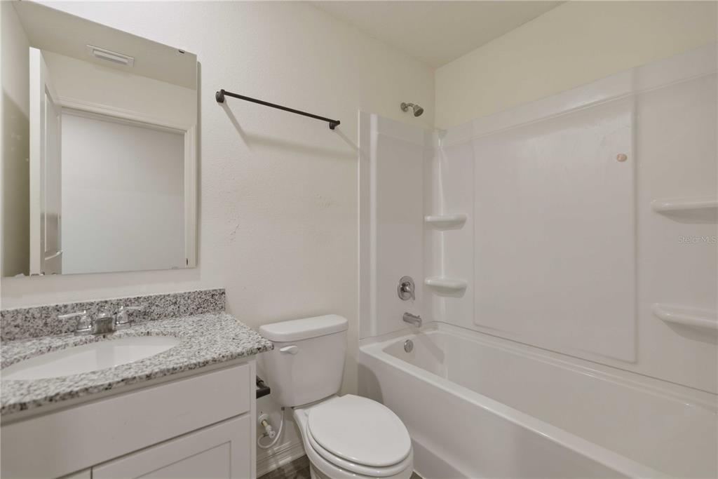 260 Emerald Road Ocala, FL 34472 - Photo 22 of 29 a bathroom with a granite countertop toilet sink and shower